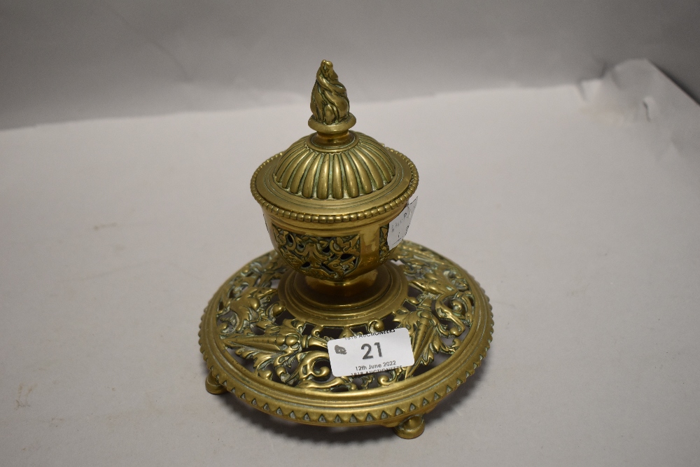 A Victorian brass ink well having lead liner and ornate styling.AF.