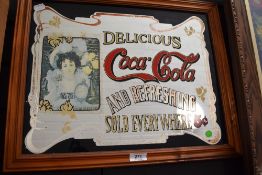A vintage advertising mirror for Coca Cola