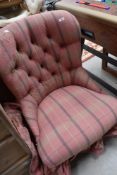 A deep buttoned easy chair of 19th century design