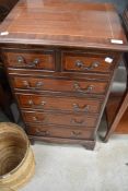 A set of Edwardian draws, two over four, having inlaid detailing.