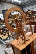 A modern lightwood spinning wheel of traditional design