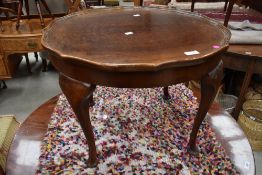 A 1930s occasional table having fluted edge.