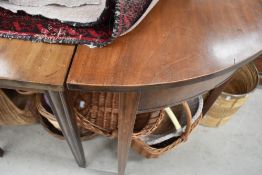 A 19th Century mahogany D end banquetting table having three centre leaves