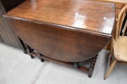 An early 20th Century oak twist gateleg dining table, width approx. 106cm