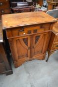 An early 20th century cupboard having carved detailing and Macintosh styling.
