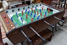 A Sardi (Italy) fuseball table, with faux burr wood effect decoration.