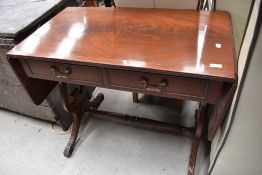 A reproduction Regency sofa style table having drop ends and metal claw feet