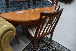 A vintage teak G plan circular dining table and set of four railback dining chairs