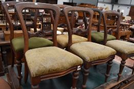 Six Victorian mahogany balloon back chairs having moulded middle rail, serpentine fronts and