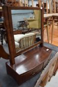 An early 20th century dressing table mirror having band fronted curved drawer base