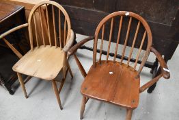 Two vintage hoop and stick back carver chairs, one marked Ercol, the other having been stripped