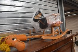 A vintage children's Pegasus rocking horse, sold together with a similar hobby horse