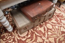 A vintage leather effect suitcase together with a ribbed travel trunk
