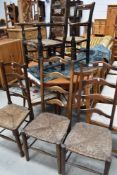 Five assorted traditional rush seated chairs including ladder back and carvers