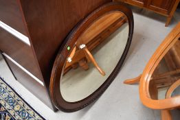 An early 20th Century mahogany oval wall mirror