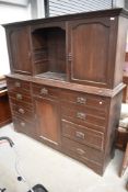 A Victorian mahogany cabinet having central shelves flanked by cupboards to top section with central