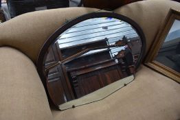 A 1920's oval oak framed bevelled mirror, together with a shaped rectangular frameless mirror