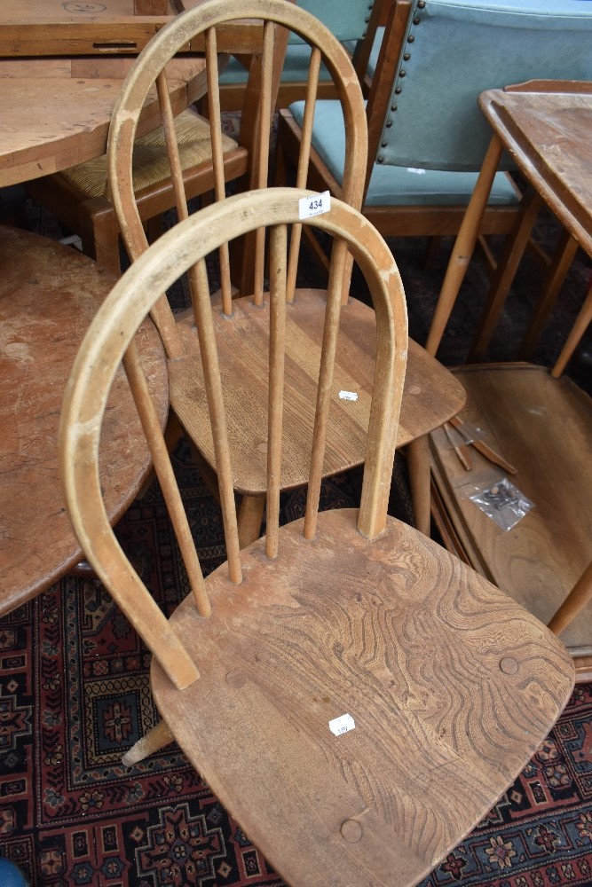 Two Ercol elm seated stick/hoop back chairs, each lacking label but bearing BS stamp.