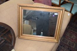 A gilt and gesso framed antique hall way mirror