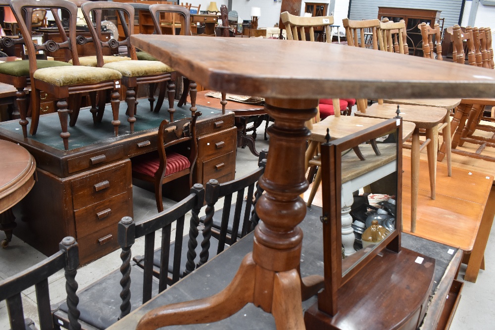 A 19th century mahogany stem table, with rounded rectangular top above a turned column issuing three