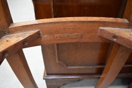 A Gordon Russell Ltd oak single chair with upholstered drop in seat, bearing manufacturers label.