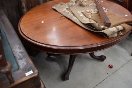 A late Victorian mahogany table of ovoid form having baluster centre support, and carved legs,with