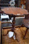 A vintage mahogany occasional table having scalloped edge.