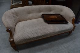 An Edwardian light mahogany framed salon style settee or couch with carved arm detailing