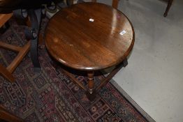 A small circular oak framed coffee table