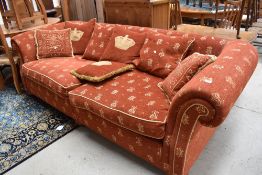 A Gascoyne Design' 3-4 seater settee & scatter cushions, in russet and gold, some cushions with