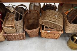 A large selection of woven wicker hand baskets, approximately 20 in total