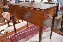An Edwardian drop leaf table having single draw to one end with dropper handles,faux draw to other