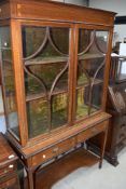 An Edwardian mahogany display cabinet on stand having glazed top with velvet lined shelves, two