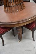 A Victorian extending mahogany dining table with fluted baluster legs on castors.