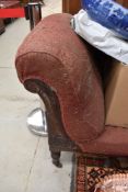 A late Victorian chaise longue, with scrolled over 'arm' and turned supports, requires re-