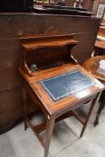 An Edwardian inlaid rosewood bureau de dame, having a raised superstructure over the inkwells, pen