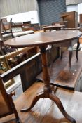 A 19th Century and later oak snap top occasional table having circular top turned column and