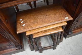 A nest of three traditional oak tables