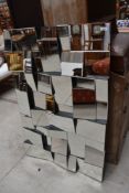 A large decorative wall mirror of modernist design