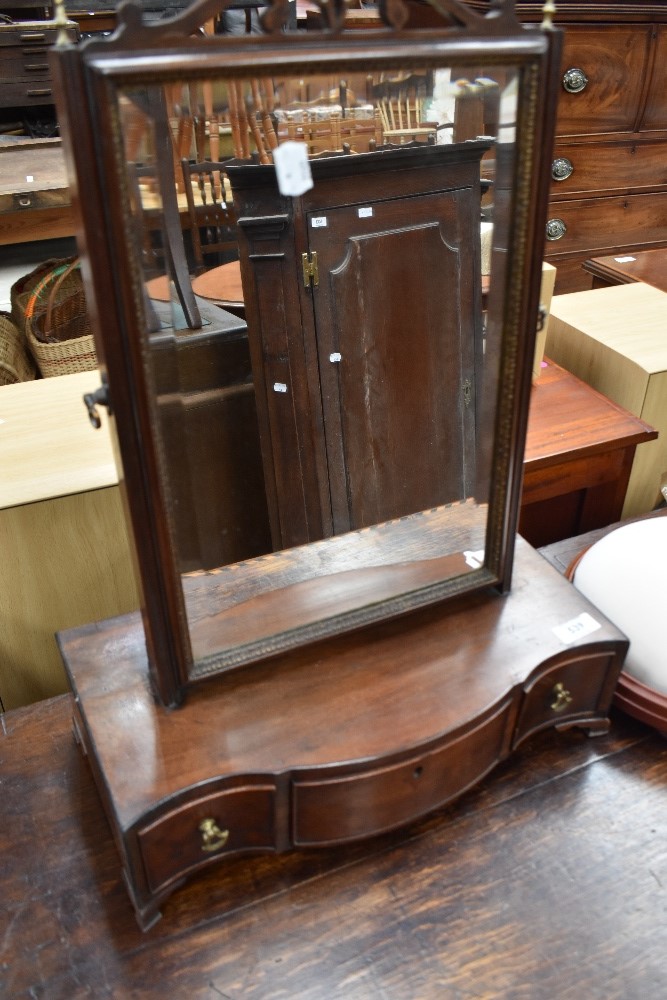 A late Georgian dressing table mirror having serpentine front and three drawers.