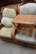 A pair of modern bent wood conservatory arm chairs with side table