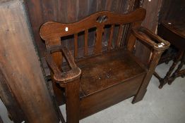 An early 20th Century oak box seat, with Art Nouveau influence
