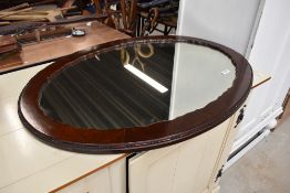 A 20th Century mahogany oval wall mirror