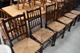 A set of six farmhouse style chairs, having spindle backs and rush seats.