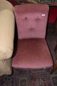 A Victorian nursing chair having later dralon pink upholstery, on turned leg and pot castors