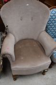 A traditional arm chair in beige fabric.