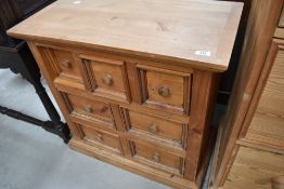 A natural pine small merchants style chest of drawers