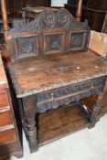 A period oak hall table having heavy carved panel back , frieze drawer and turned legs, width