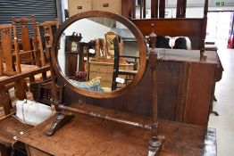 A reproduction oak oval toilet mirror