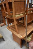 An Art Deco light oak drawer leaf dining table and six chairs, in the manner of Heals (unmarked)